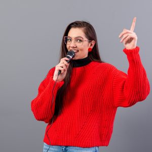 female-conference-speaker-dressed-in-a-red-sweater-2023-11-27-04-50-18-utc